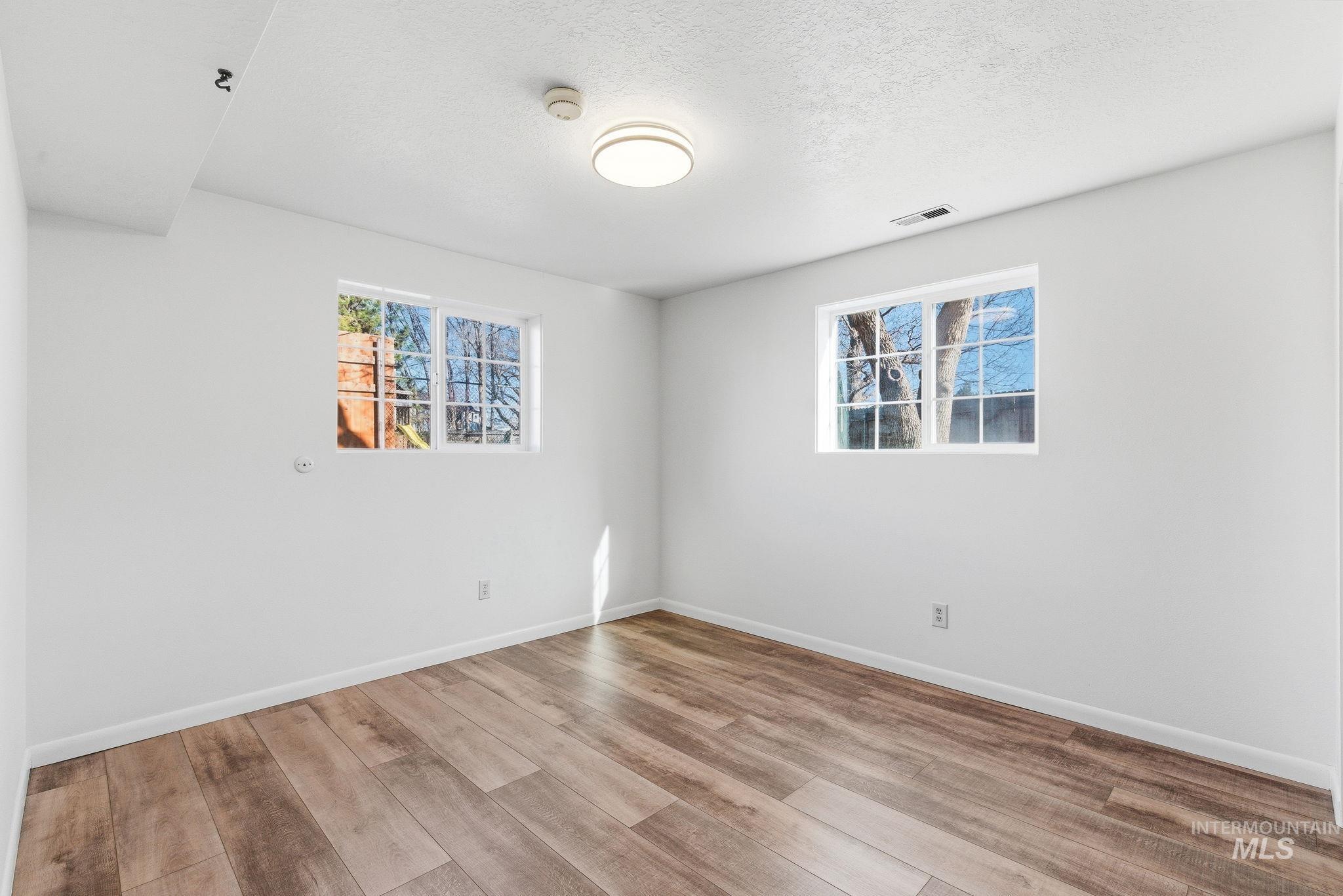 2072 South Crystal Way Boise, ID 83706 - Photo 37 of 50 Spare room featuring light wood-style flooring and a textured ceiling