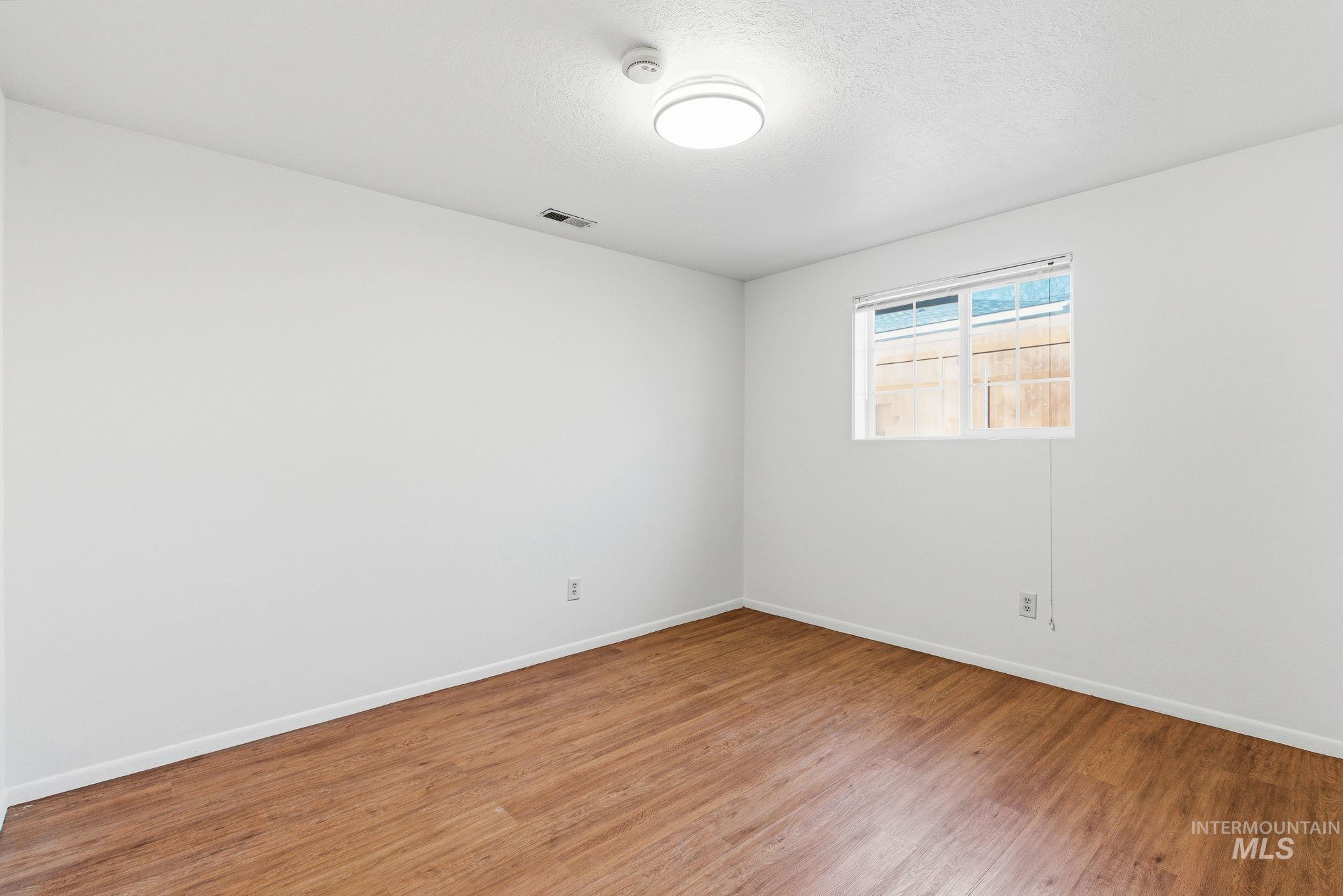 2072 South Crystal Way Boise, ID 83706 - Photo 38 of 50 Empty room featuring baseboards and wood finished floors