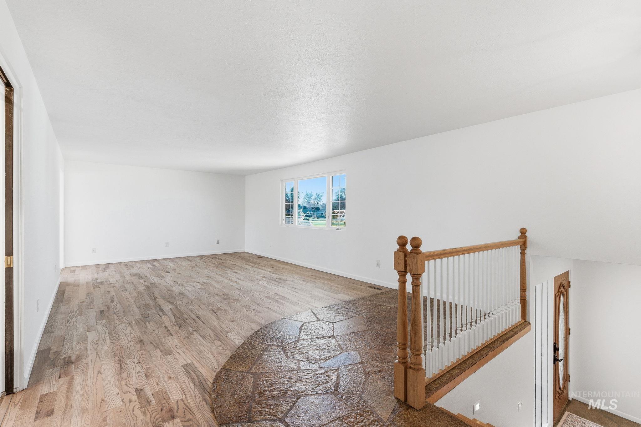 2072 South Crystal Way Boise, ID 83706 - Photo 5 of 50 Empty room with light wood-style flooring and baseboards