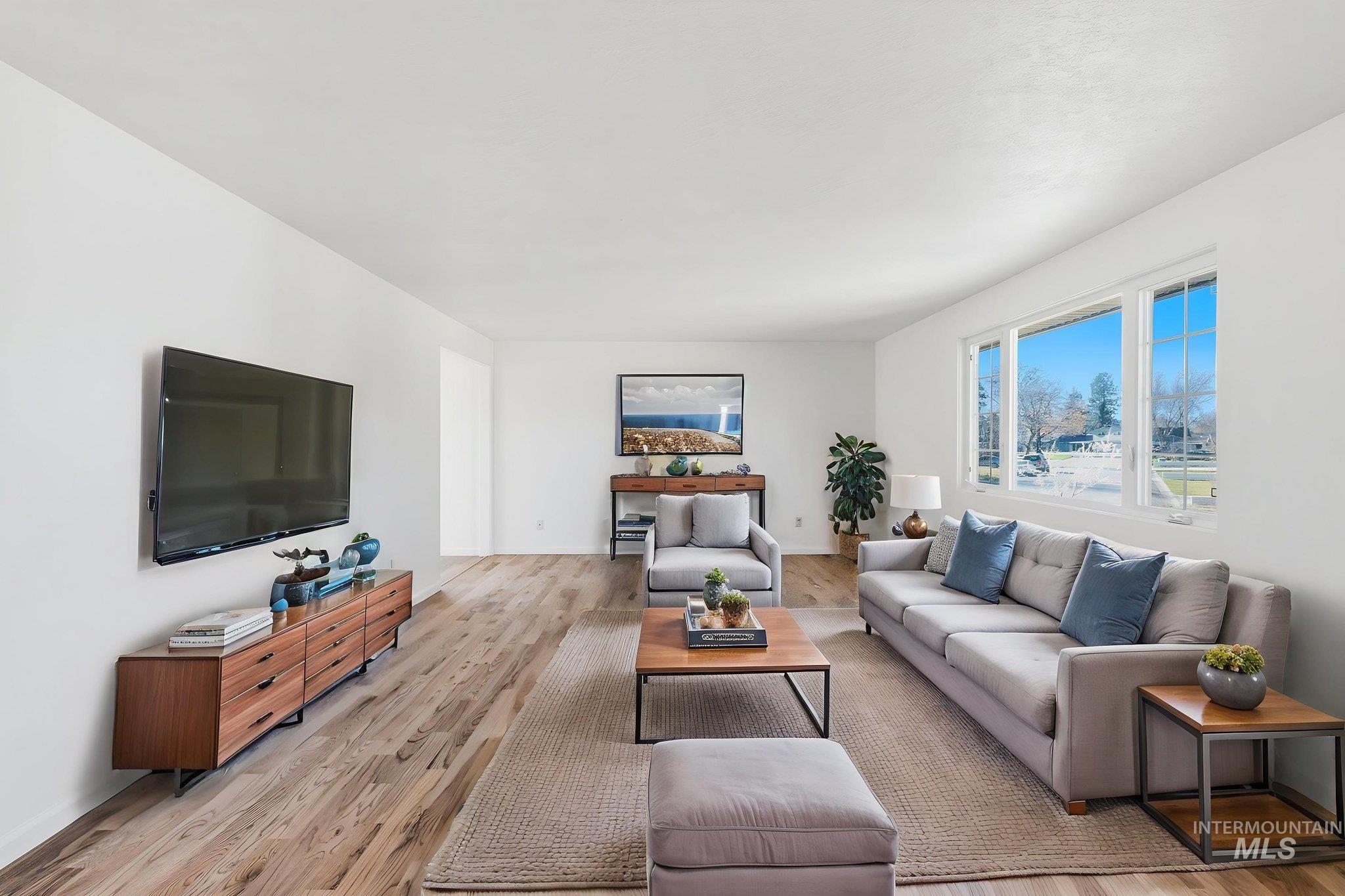 2072 South Crystal Way Boise, ID 83706 - Photo 7 of 50 Living area with light wood-style flooring and baseboards