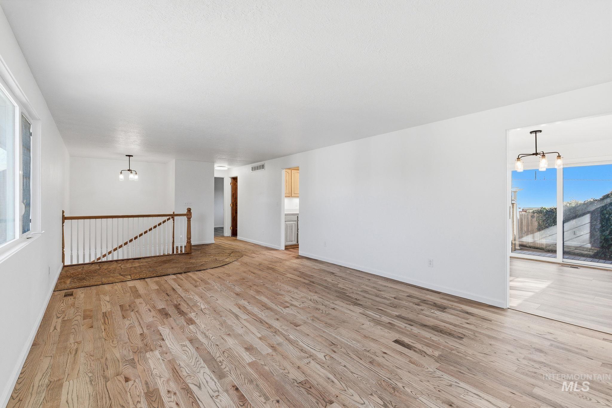2072 South Crystal Way Boise, ID 83706 - Photo 8 of 50 Unfurnished room featuring a chandelier and light wood finished floors