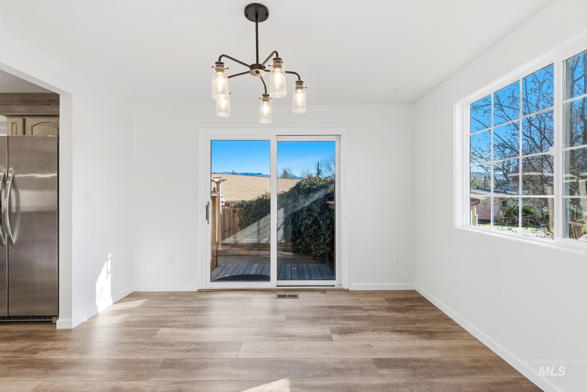 2072 South Crystal Way Boise, ID 83706 - Photo 10 of 50 Unfurnished dining area featuring suspended lighting and light wood finished floors