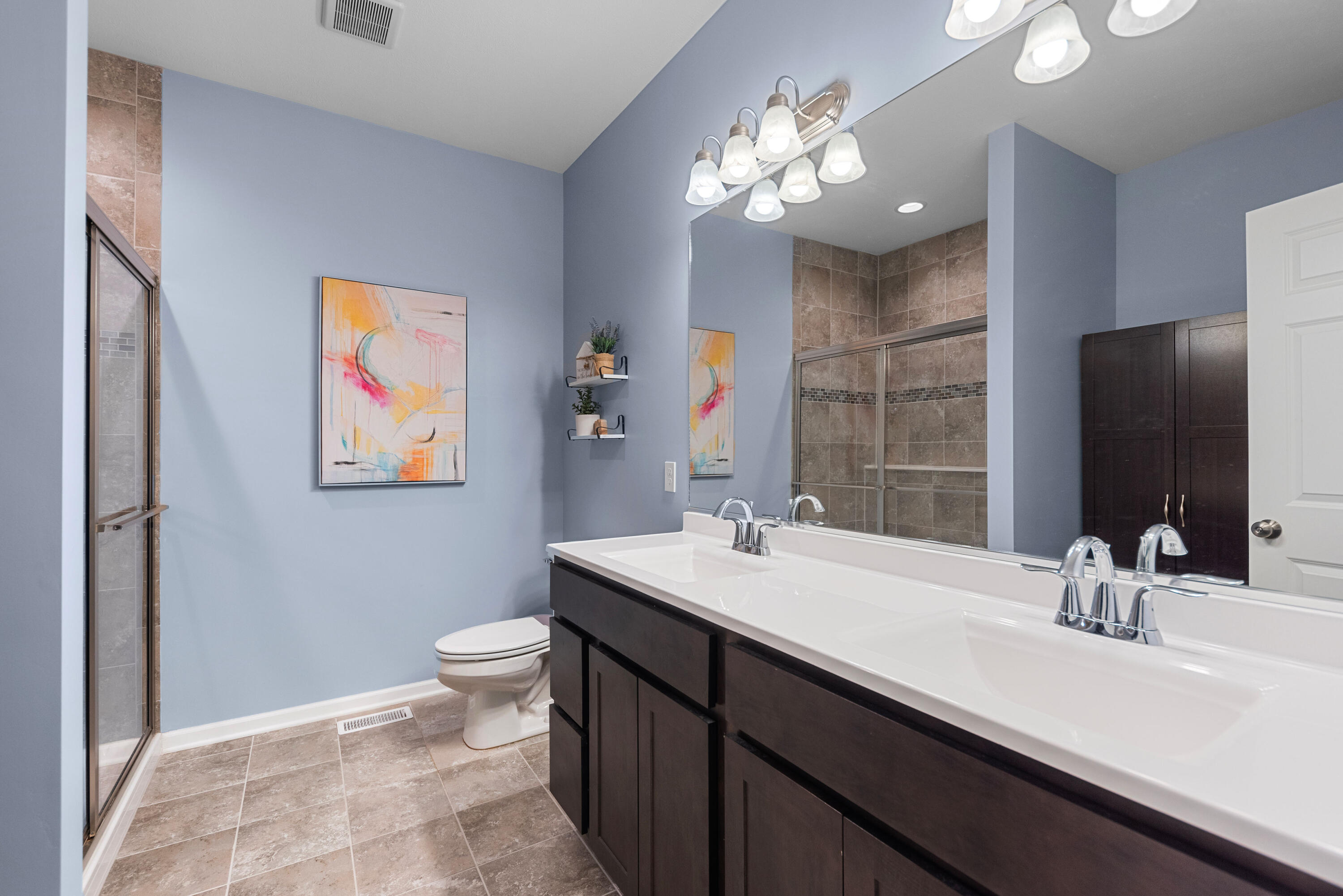 2451 Ritter Street Chesterton, IN 46304 - Photo 6 of 18 a bathroom with a double vanity sink mirror and toilet