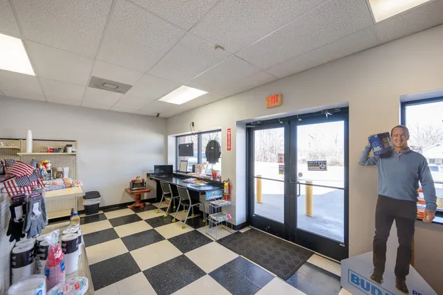 a view of a workspace with furniture and a window