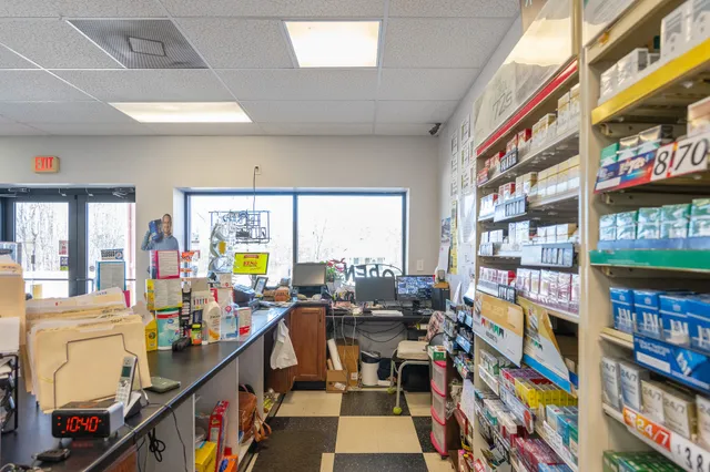a room with furniture lots of books and a large window