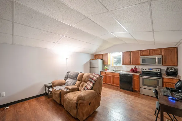 a kitchen with stainless steel appliances a stove microwave and refrigerator