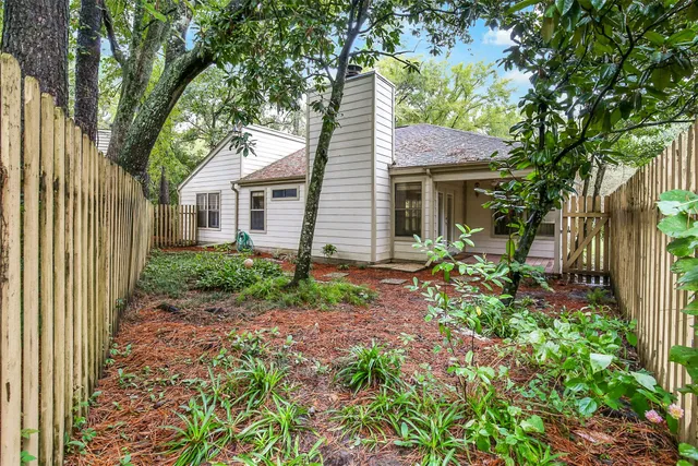 a view of a house with a yard and potted plants