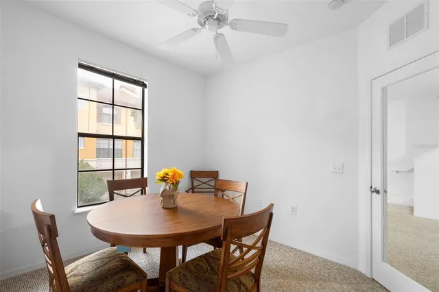 a view of a dining room with furniture and window