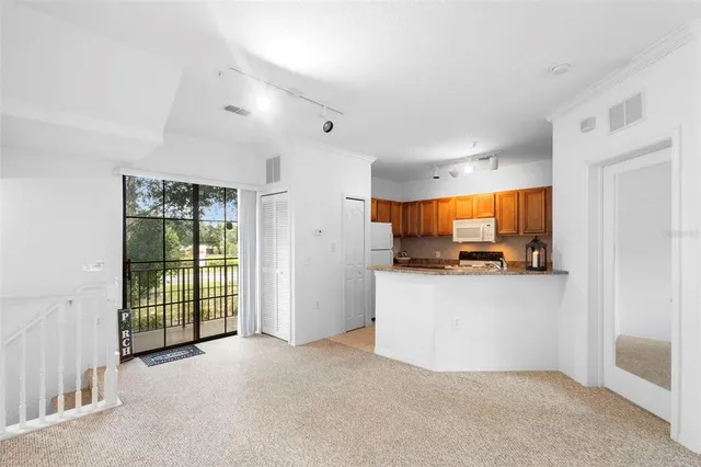 a kitchen with stainless steel appliances a refrigerator a sink a stove top oven and a window