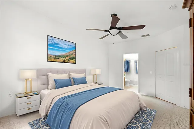 a bedroom with a bed and a painting on the wall