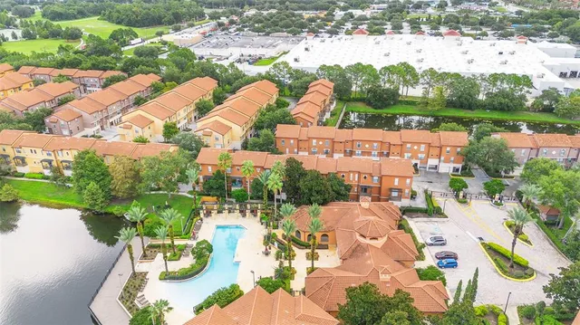 an aerial view of a city with garden and lake view