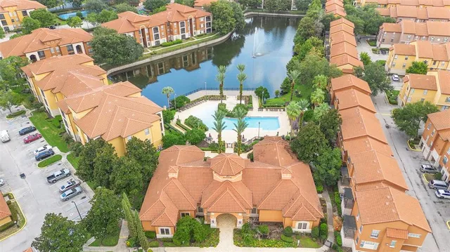 an aerial view of a house a yard and lake view