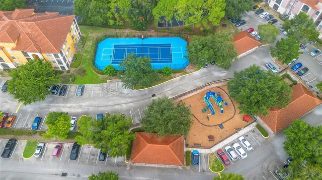 an aerial view of a brick wall with plants and large trees