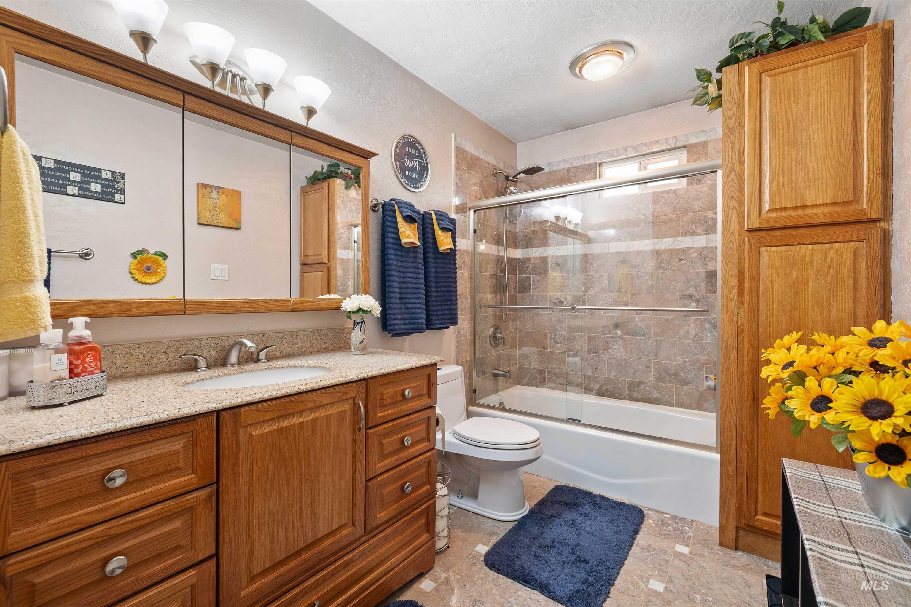 216 Ranch View Road West Jerome, ID 83338 - Photo 20 of 42 Wood-finish vanity with an integrated sink and light-colored countertop