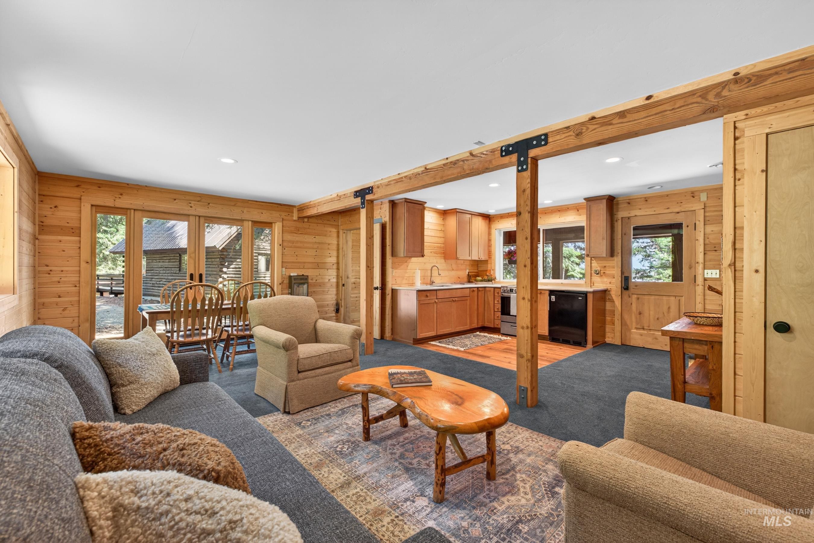 2339 West Mountain Road Donnelly, ID 83615 - Photo 26 of 37 Open concept living space featuring wood paneling, exposed wood beams, and recessed lighting