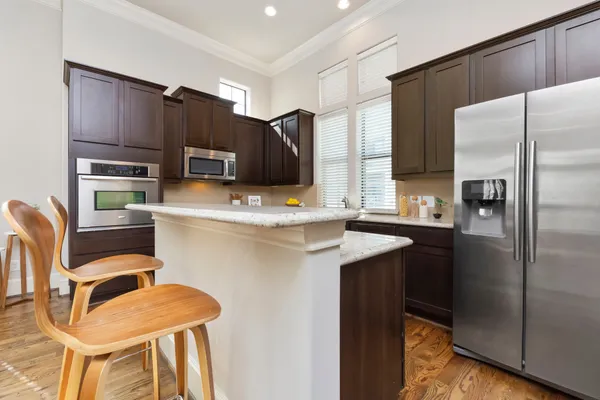 a kitchen with stainless steel appliances a refrigerator and a stove top oven