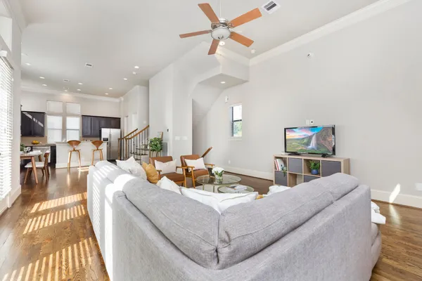 a living room with furniture and a wooden floor