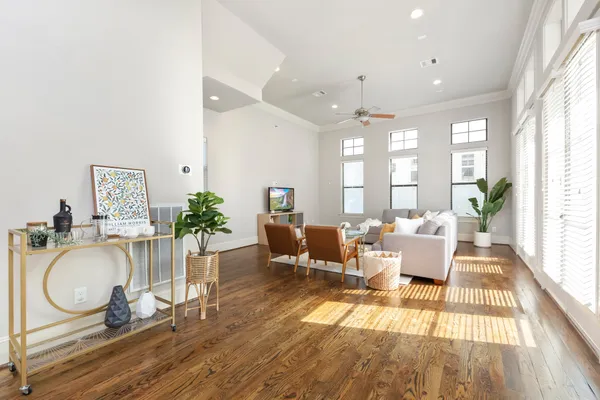 a very nice looking living room with wooden floor and furniture