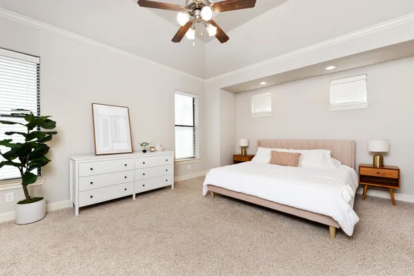 a room with a bed dresser and a window