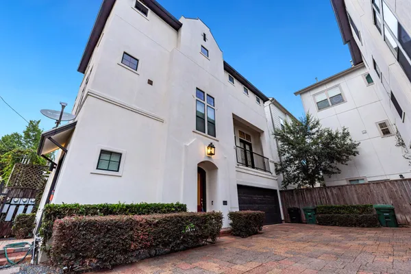 a front view of a house with plants