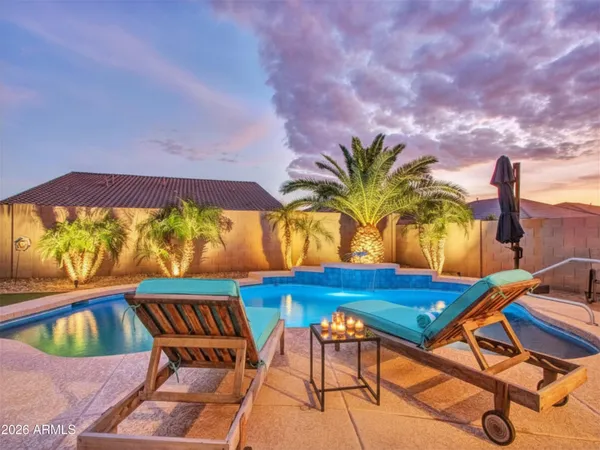 a view of a backyard with lawn chairs