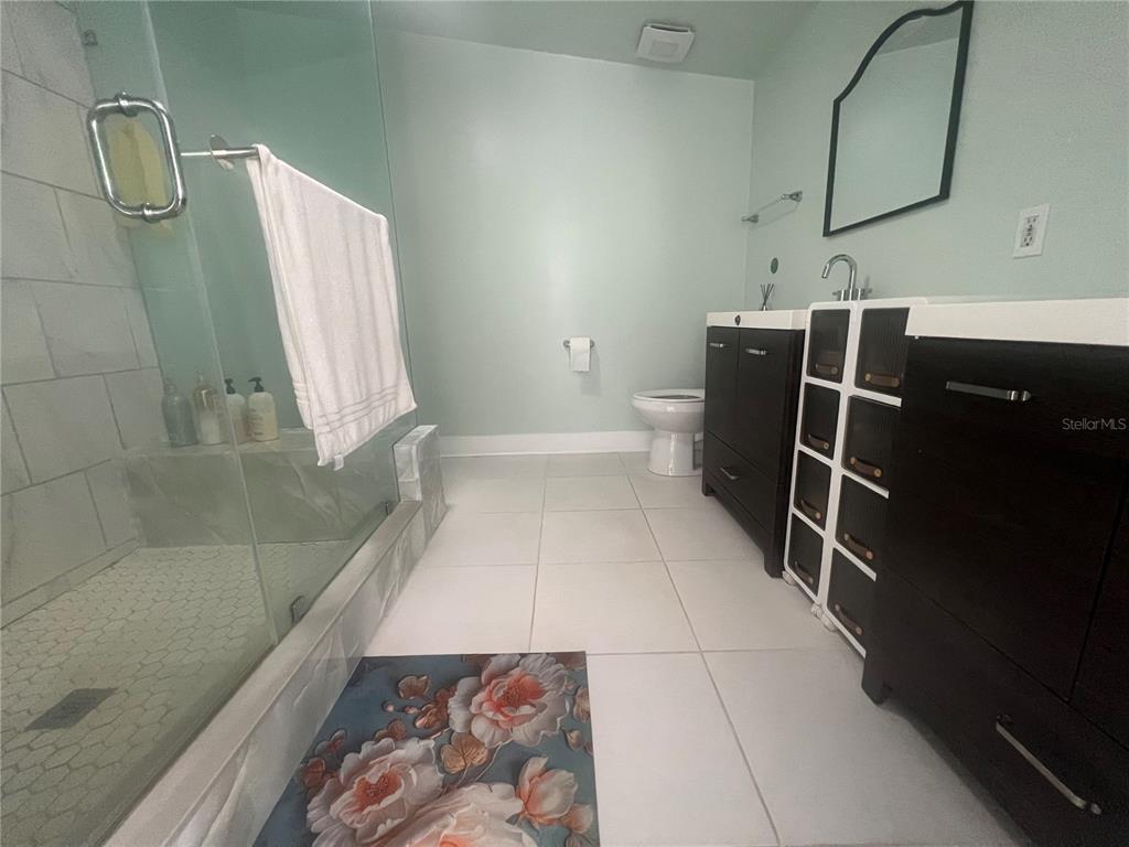 5855 Jack Brack Road St. Cloud, FL 34771 - Photo 12 of 86 a bathroom with a sink and a mirror