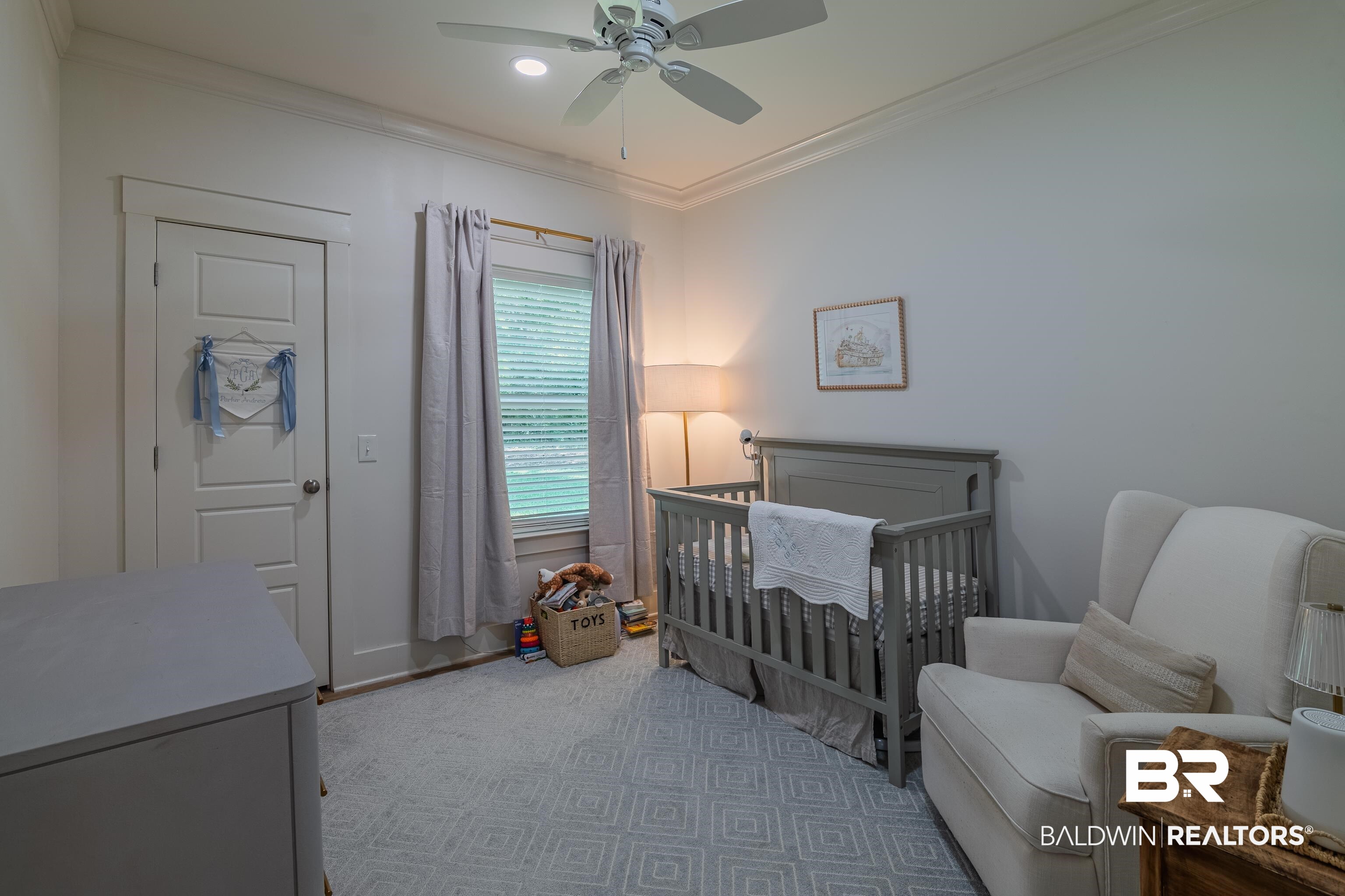 19121 Boothe Road Fairhope, AL 36532 - Photo 21 of 41 Bedroom with a crib, crown molding, and ceiling fan