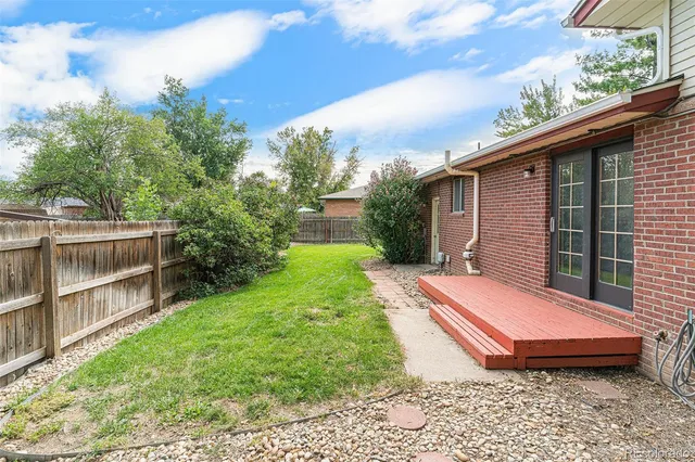 a view of a backyard with sitting area