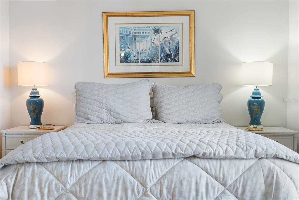 6322 Palma Del Mar Boulevard South, Unit 209 St. Petersburg, FL 33715 - Photo 14 of 42 a bedroom with a bed and wall painting