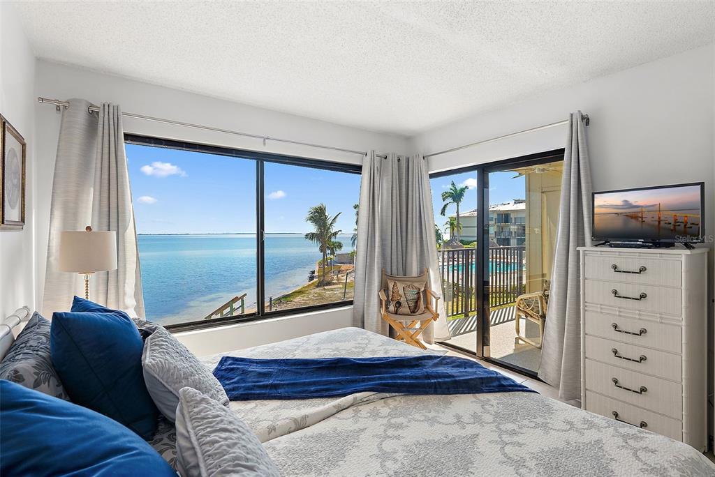 6322 Palma Del Mar Boulevard South, Unit 209 St. Petersburg, FL 33715 - Photo 18 of 42 a bedroom with a bed and large window