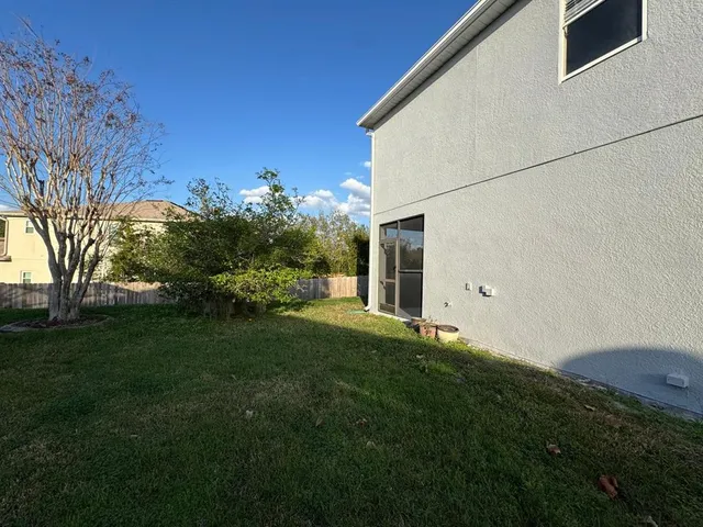 a view of a house with a backyard