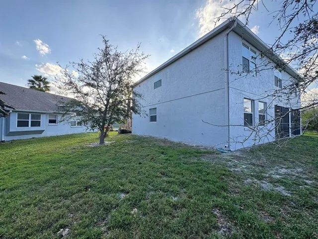 a view of a house with a backyard