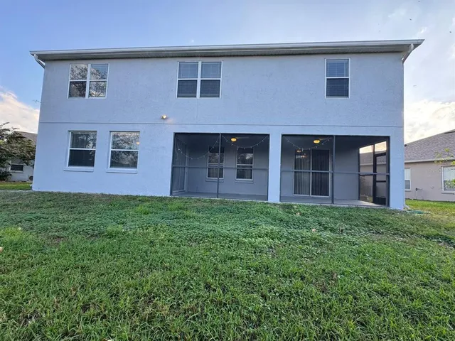 a view of a brick house with a yard