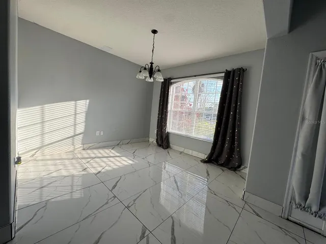 a view of a room with window and hardwood