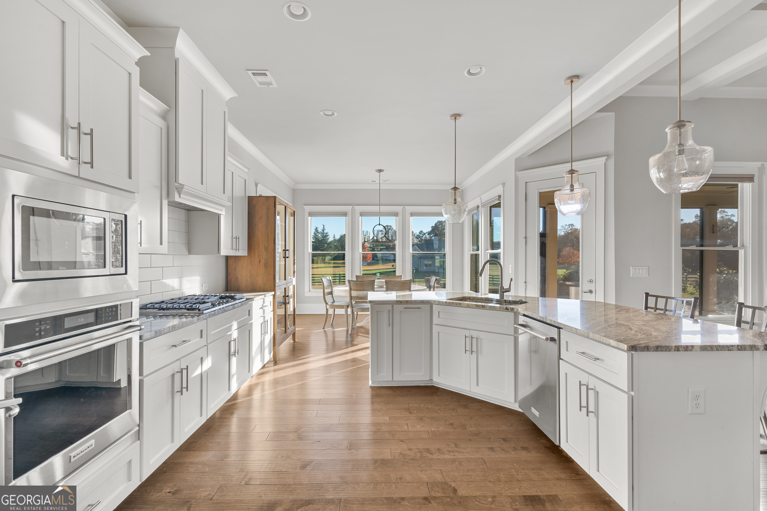 652 Meadow Run Court Clarkesville, GA 30523 - Photo 30 of 61 a large kitchen with stainless steel appliances lots of counter space and wooden floor