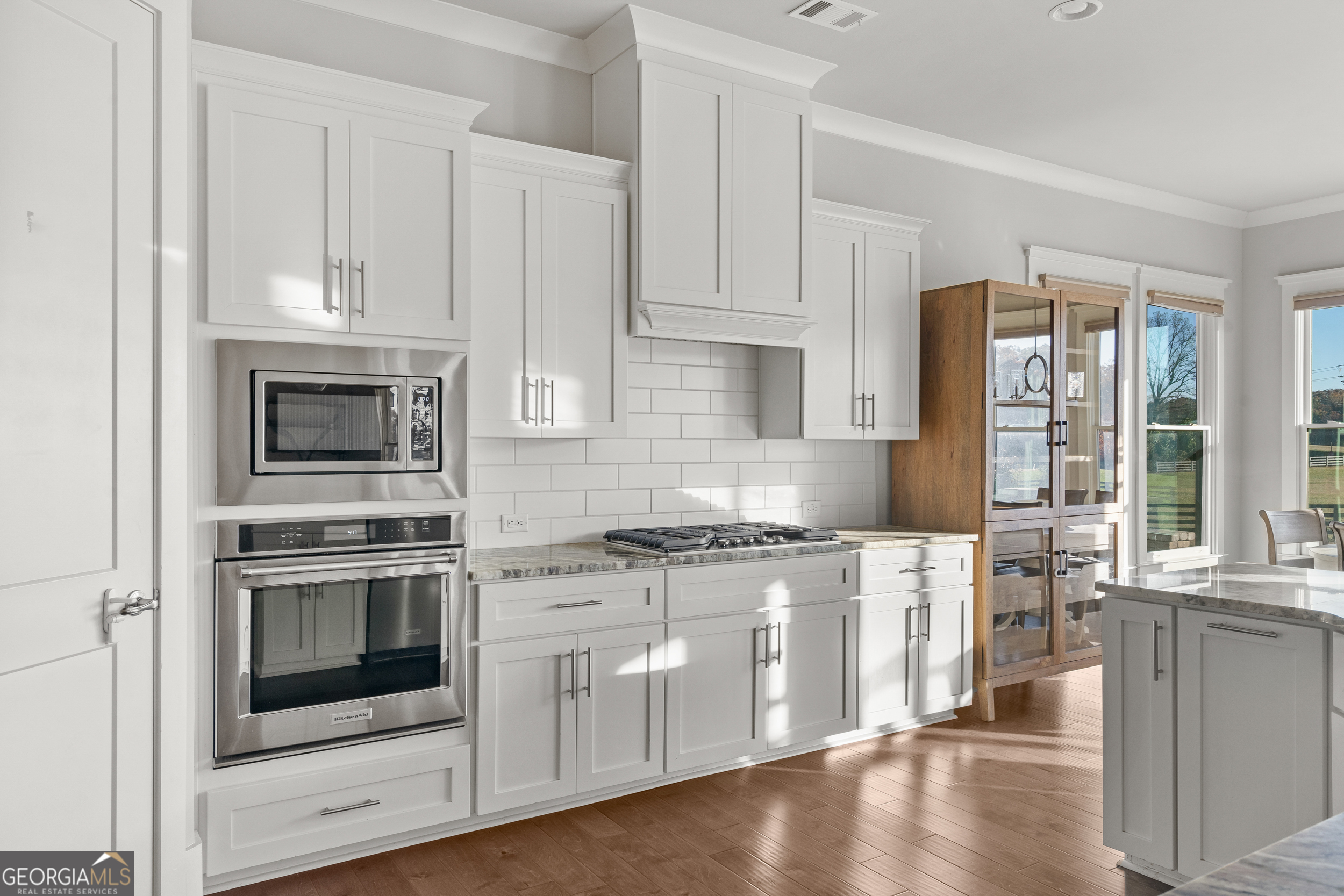 652 Meadow Run Court Clarkesville, GA 30523 - Photo 32 of 61 a kitchen with stainless steel appliances white cabinets and a stove