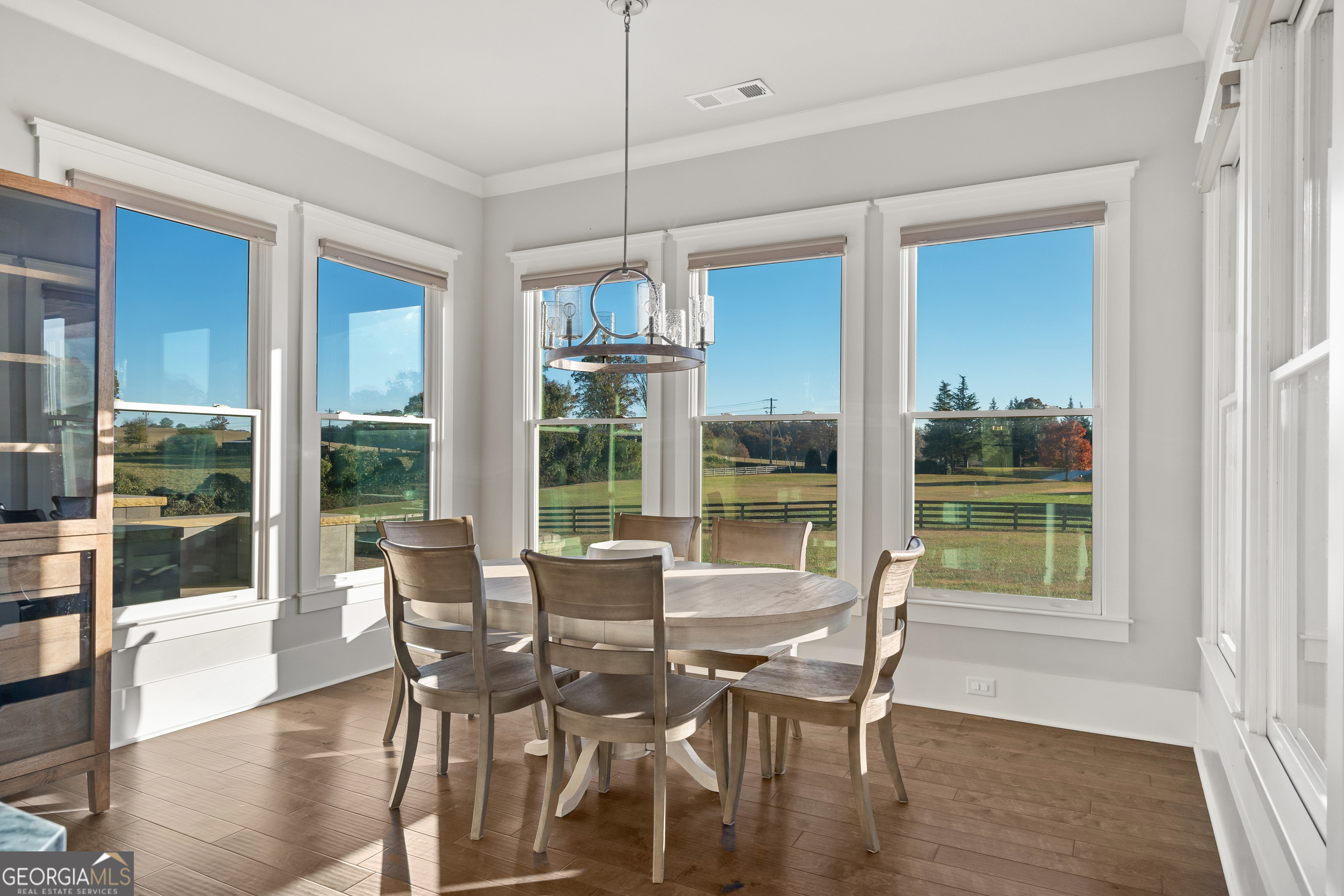 652 Meadow Run Court Clarkesville, GA 30523 - Photo 33 of 61 a view of a dining room with furniture large windows and wooden floor
