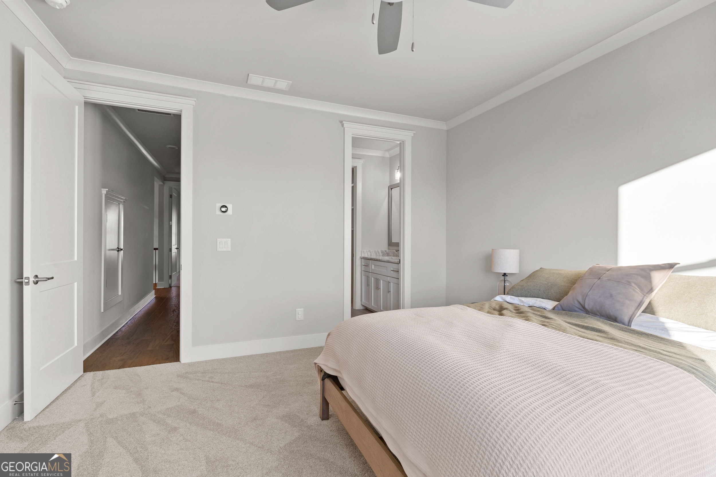 652 Meadow Run Court Clarkesville, GA 30523 - Photo 54 of 61 a bedroom with a large bed and a chandelier