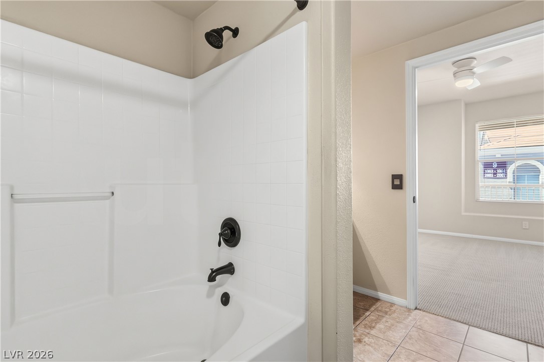 10550 West Alexander Road, Unit 2060 Las Vegas, NV 89129 - Photo 28 of 45 A well-appointed bathroom features a tub-shower combination with contemporary dark bronze fixtures.