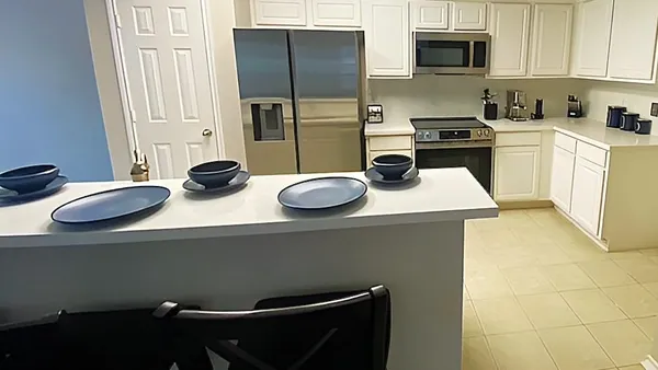 a kitchen with stainless steel appliances a sink a stove and refrigerator