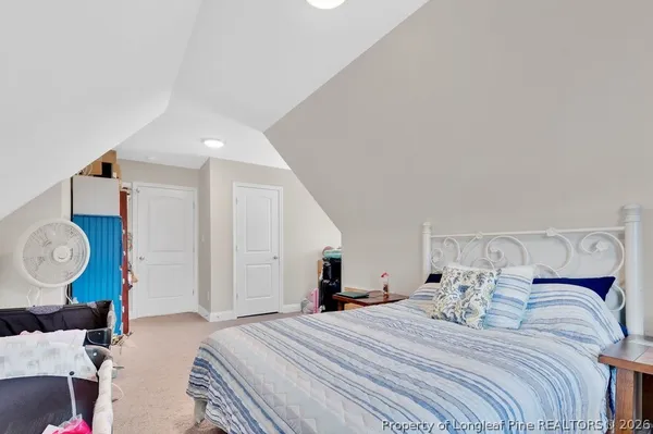 a bedroom with bed and wooden floor