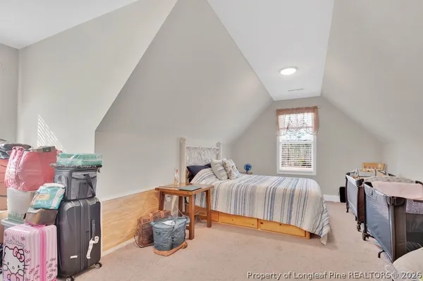 a bedroom with furniture and a window