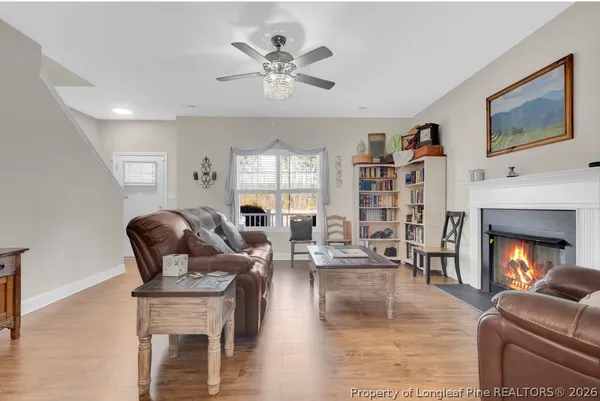 a living room with furniture fireplace and window