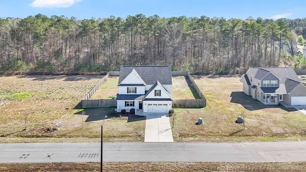 a front view of a house with trees