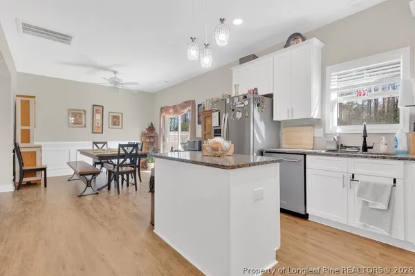 a living room with granite countertop kitchen island furniture and a large window