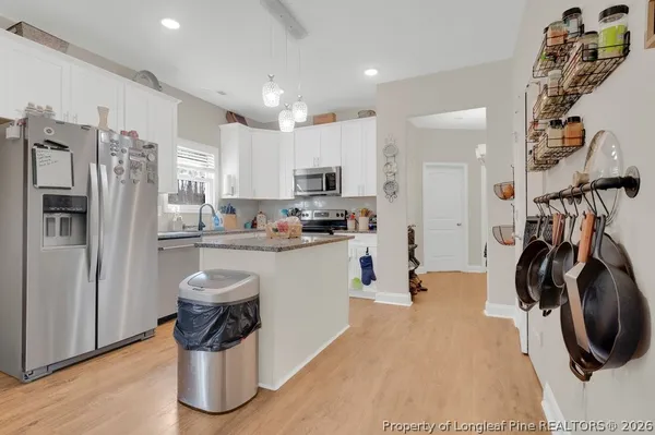 a kitchen view of a refrigerator and a sink