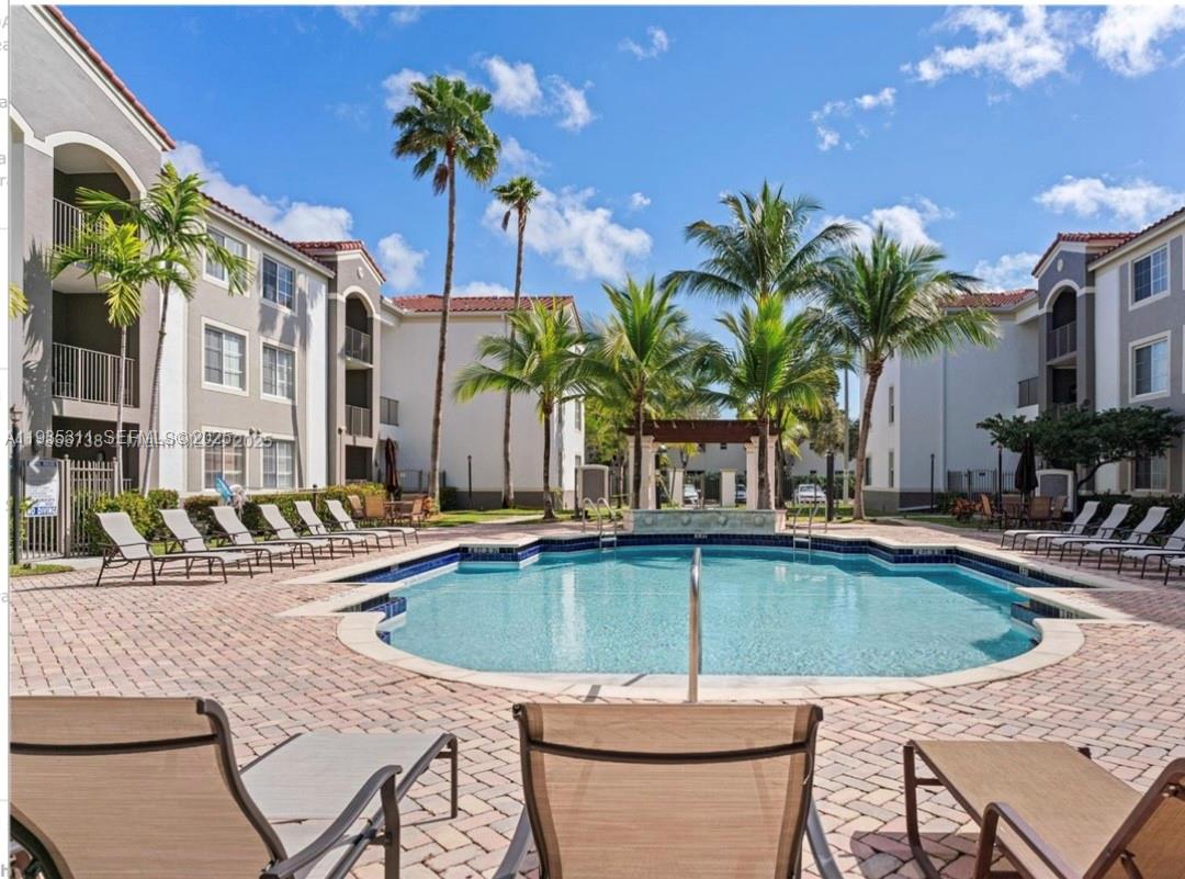 6851 Southwest 44th Street, Unit 308 Miami, FL 33155 - Photo 11 of 13 a view of a backyard with swimming pool and furniture