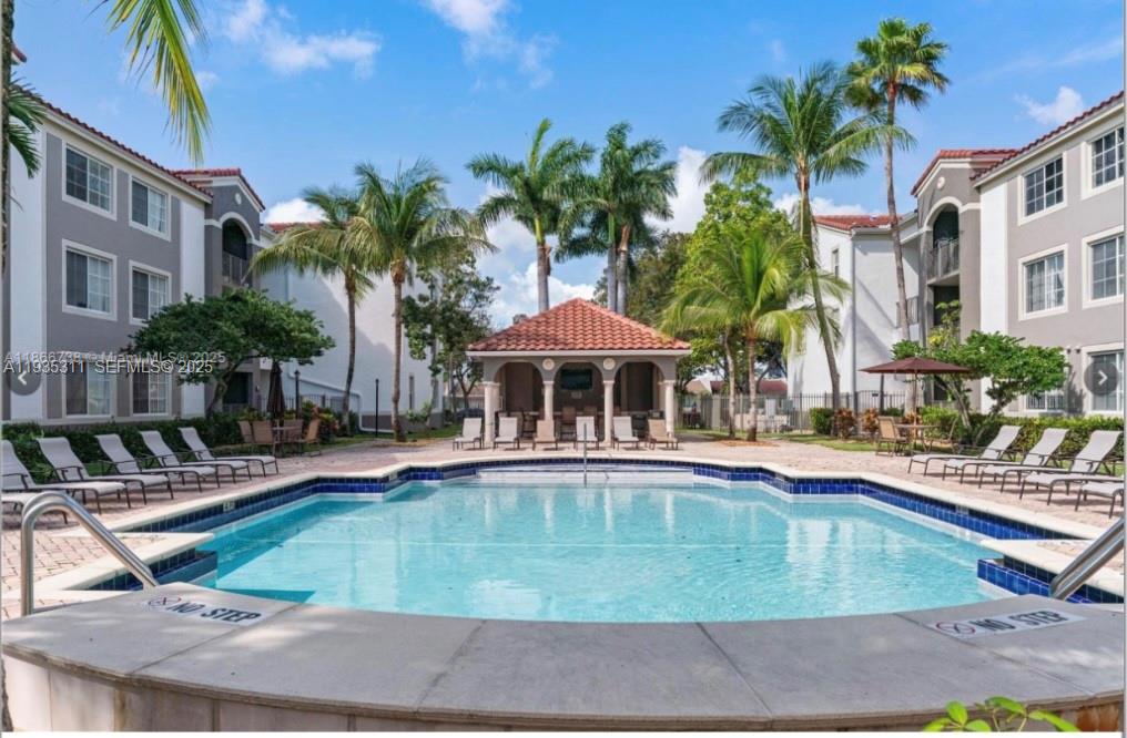 6851 Southwest 44th Street, Unit 308 Miami, FL 33155 - Photo 12 of 13 a view of a swimming pool with chairs