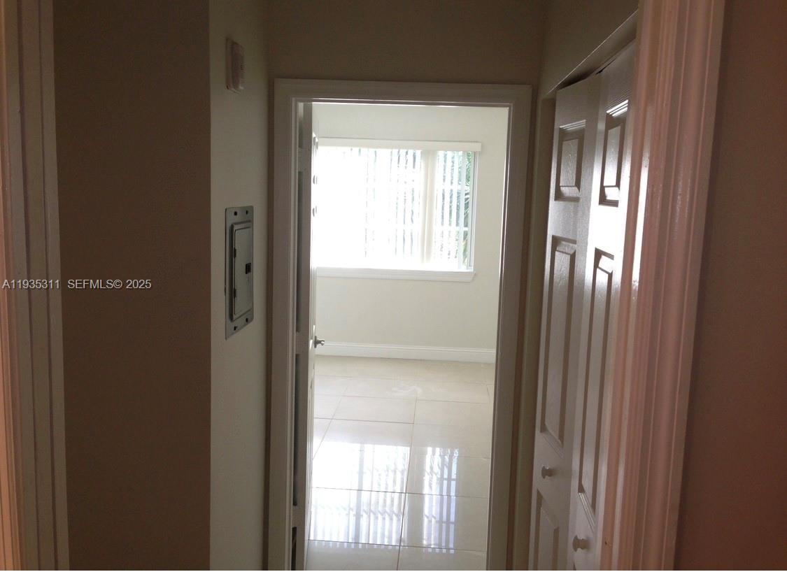 6851 Southwest 44th Street, Unit 308 Miami, FL 33155 - Photo 4 of 13 a view of an empty room with a window