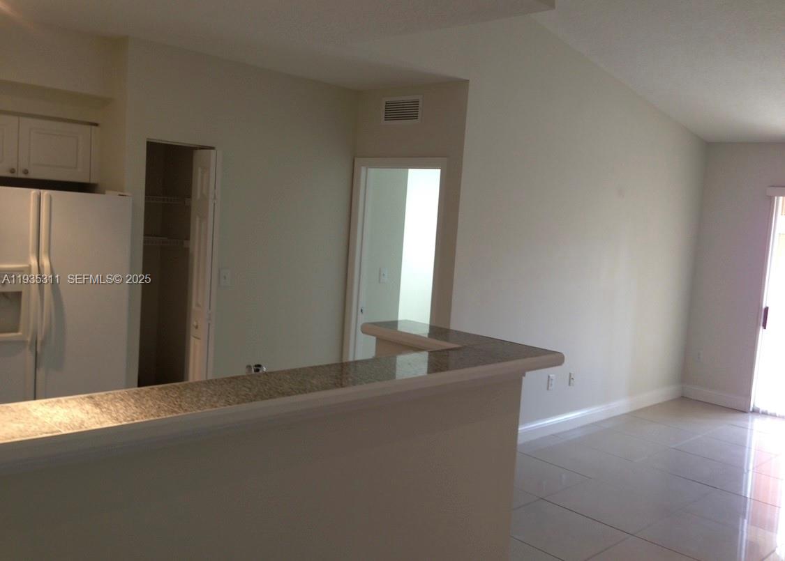 6851 Southwest 44th Street, Unit 308 Miami, FL 33155 - Photo 5 of 13 a view of an empty room and window